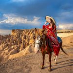 tourists enjoy ride horses cappadocia turkey